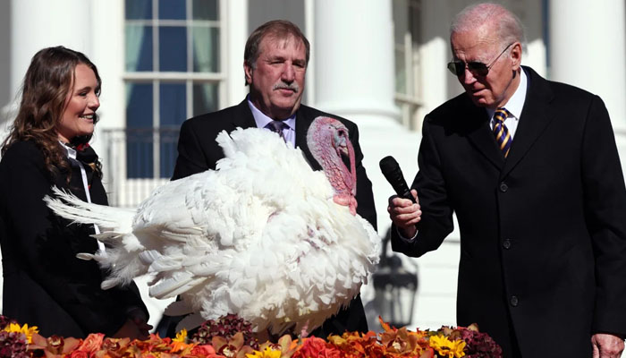 US President Joe Biden pardons Chocolate, the National Thanksgiving Turkey, as he is joined by the 2022 National Turkey Federation Chairman Ronnie Parker and Alexa Starnes, daughter of the owner of Circle S Ranch, on the South Lawn of the White House November 21, 2022, in Washington, DC. — X/@winmcnamee
