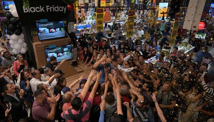 Shoppers buy TV sets at a supermarket during a Black Friday sale in Sao Paulo, Brazil, November 23, 2023. — AFP