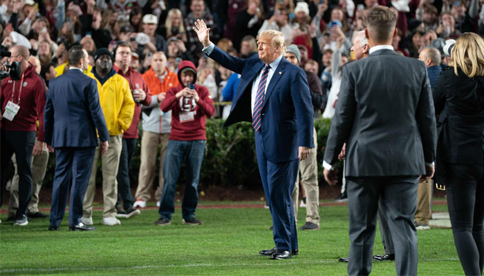 Former US president Donald Trump waves to the crowd during halftime in the Palmetto Bowl between Clemson and South Carolina at Williams Brice Stadium on November 25, 2023, in Columbia, South Carolina. — AFP