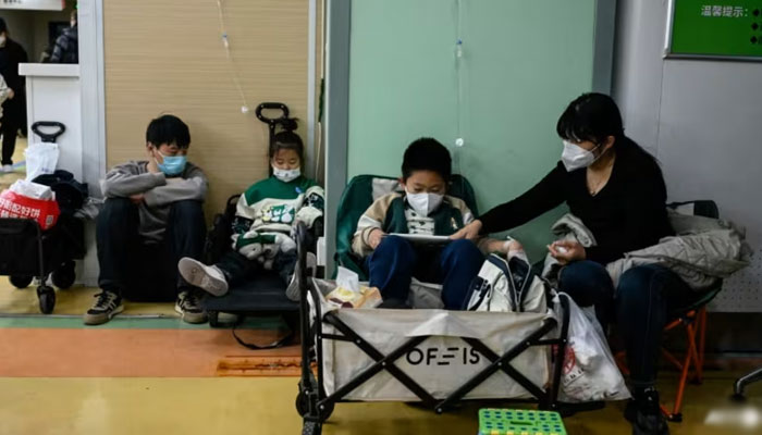 Parents accompany their sick children at a hospital in China. — AFP/File