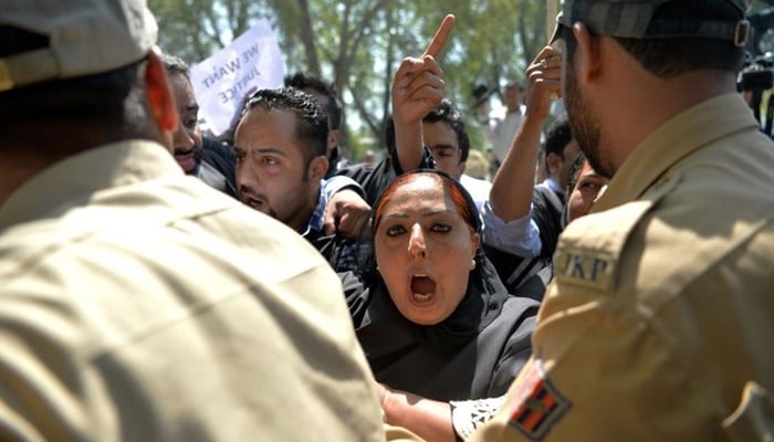 Members of the youth wing of IIOJK main opposition National Conference party shout anti-government slogans during a protest against police violence involving students in central Srinagar on April 18, 2017. — AFP