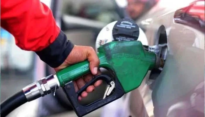 Fuel station attendant filling up a car at a petrol station. — AFP/File
