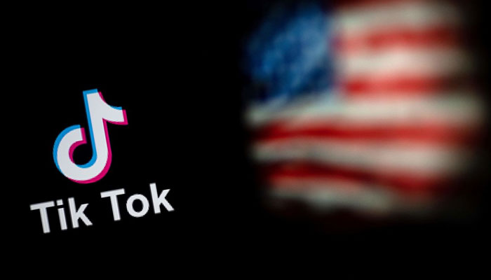 This illustration shows the logo of the social network application TikTok (top) and a US flag (bottom). — AFP/File