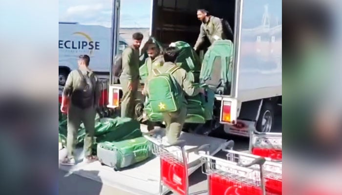 Pakistani cricketers loading their luggage onto a container truck in this still taken from a video. — X/ @CricketopiaCom/File