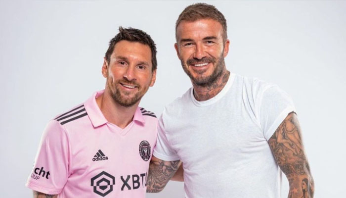 Lionel Messi and David Beckham gesture during a photo session. — X/@cedoc