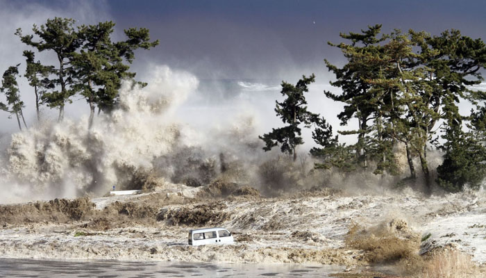 Tsunami waves hit the coast of Minamisoma in Fukushima Prefecture in Japan photographed on March 11, 2011 by Sadatsugu Tomizawa and released via Jiji Press on March 21, 2011. — AFP