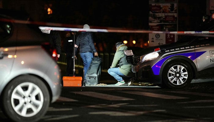 Forensic police work at the scene of a stabbing in Paris on December 2, 2023. — AFP
