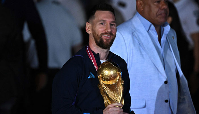 Argentina´s captain and forward Lionel Messi (centre) holds the FIFA World Cup Trophy upon arrival at Ezeiza International Airport after winning the Qatar 2022 World Cup tournament in Ezeiza, Buenos Aires province, Argentina on December 20, 2022. — APF