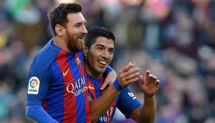 Lionel Messi (left) celebrates with Luis Suarez in this undated picture. — AFP/File