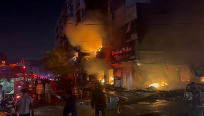 A fire engine parked beside the building that caught fire near Karachi’s Ayesha Manzil, on December 6, 2023, in this still taken from a video. — Thenews.com.pk via Syed Daniyal Syed