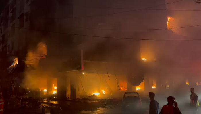 Flames can be seen coming out of the building that caught fire near Karachi’s Ayesha Manzil, on December 6, 2023, in this still taken from a video. — Thenews.com.pk via Syed Daniyal Syed