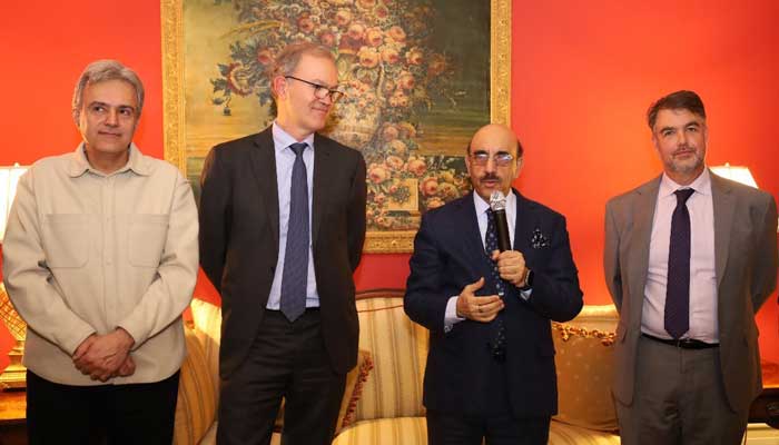 Pakistans Ambassador Masood Khan (centre) addressing an event along with officials of IFIs at Pakistan House in Washington on December 7, 2023. — X/@Masood__Khan