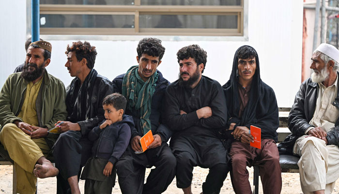 Afghan refugees returning voluntarily waiting for their turn at the United Nations High Commissioner for Refugees (UNHCR) Azakhel Voluntary Repatriation Centre in Nowshera on November 23, 2023. — AFP