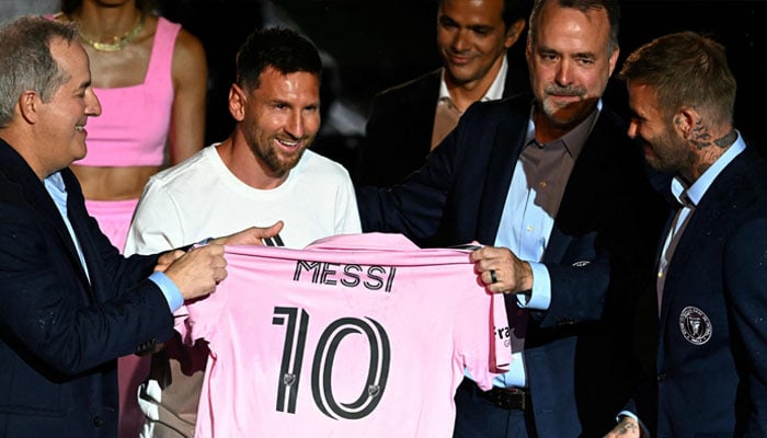 Lionel Messi is presented with his shirt by Inter Miami owners. — AFP/File