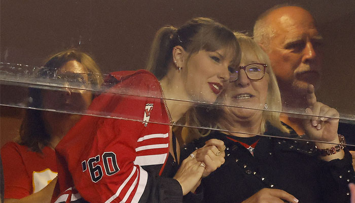 Taylor Swift whispers something into Donna Kelces ear at the Oct 12 game between Travis Kelces Kansas City Chiefs and the Denver Broncos. — X/@davideulitt