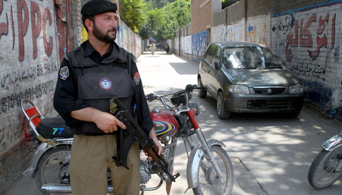 A policeman stands guard in Azad Jammu and Kashmir. — PPI/File