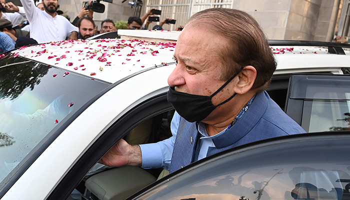 Former prime minister Nawaz Sharif (R) leaves after appearing before the High Court in Islamabad on October 24, 2023. — AFP