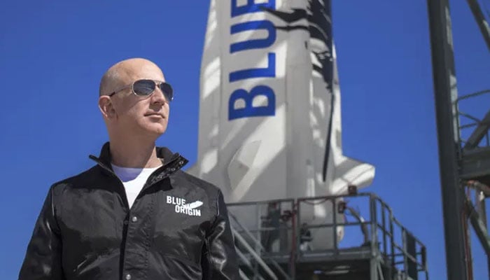 Jeff Bezos at the Blue Origin launch pad with a New Shepard rocket in the background. — Blue Origin