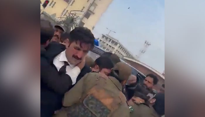 PTI Senior Vice President Sher Afzal Khan Marwat being arrested in Lahore, on December 14, 2023, in this still taken from a video. — X/@AkMashal