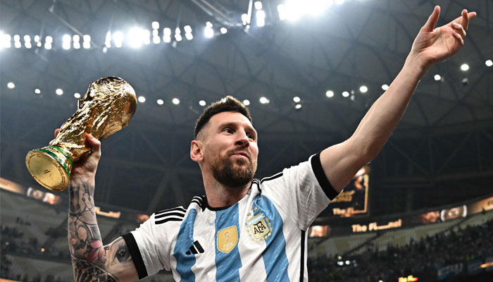 Lionel Messi poses with the Fifa World Cup Trophy after Argentina won the Qatar 2022 World Cup final football match between Argentina and France at Lusail Stadium in Lusail, north of Doha on December 18, 2022. — AFP