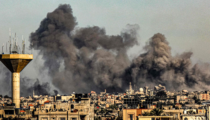 Smoke billows from Israeli bombardment over Khan Yunis from Rafah in the southern Gaza Strip on December 16, 2023