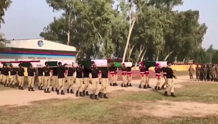 Soldiers march with coffins of security personnel who were martyred in the DI Khan suicide attack in Khyber Pakhtunkhwas DI Khan district, on December 12, 2023, in this still taken from a video. — ISPR