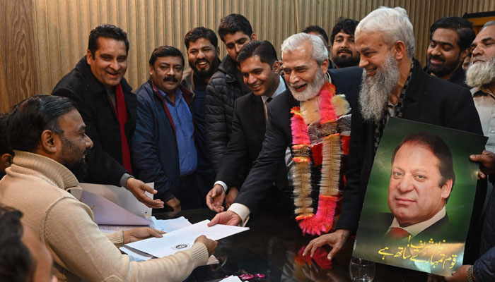 Candidates submit their nomination papers at the deputy commissioners office in Lahore on December 23, 2023, ahead of the upcoming 2024 general elections. — AFP
