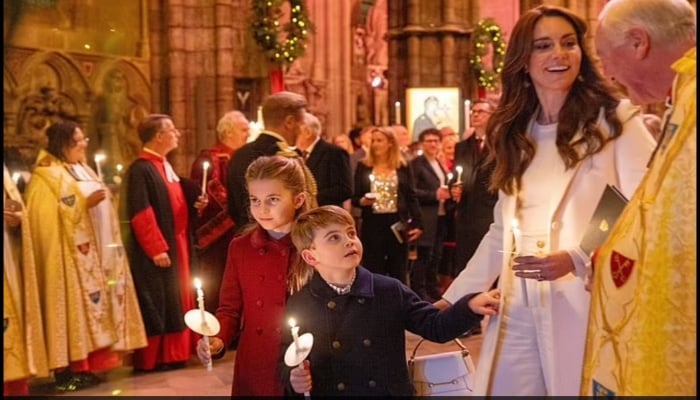 The five-year-old said to have Christmas magic in his eyes, was seen nudging his mother Kate, whispering mama