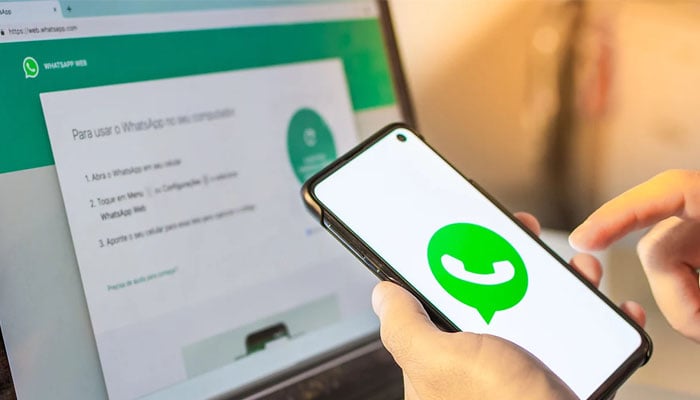 An image depicting a person connecting WhatsApp on the web via smartphone. — WhatsApp/File