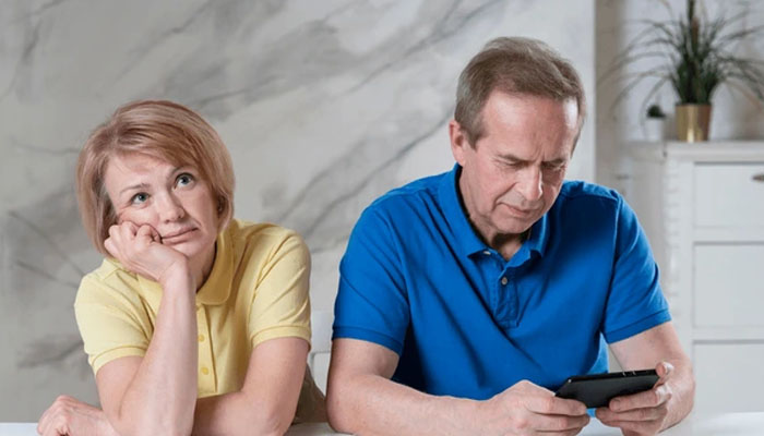 A representational image of phubbing shows a man browsing a phone while a woman gestures sitting beside him. — X/@shutterstock
