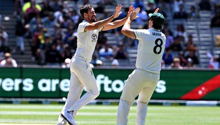 Australian bowler Mitchell Starc (L) celebrates with Mitch Marsh after dismissing Abdullah Shafique on the fourth day of the second cricket Test match between Australia and Pakistan at the Melbourne Cricket Ground (MCG) in Melbourne on December 29, 2023. —AFP