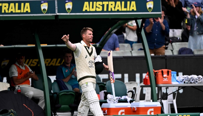 Australian batsman David Warner waves to the fans after being dismissed on the third day of the second cricket Test match between Australia and Pakistan at the Melbourne Cricket Ground (MCG) on December 28, 2023. —AFP