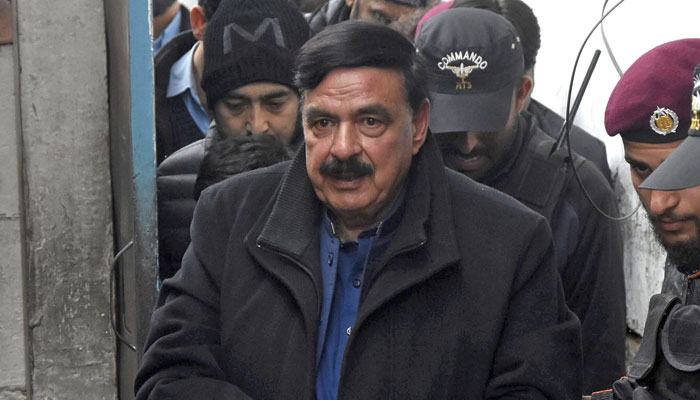 Police officials escort the Awami Muslim League (AML) chief Shiekh Rashid as he arrives to attend hearing at the additional and sessions court in Islamabad on February 2, 2023. — Online