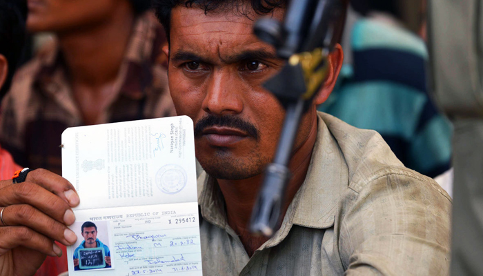 A freed Indian fisherman displays his passport after arriving at the Wagah border. — AFP/File