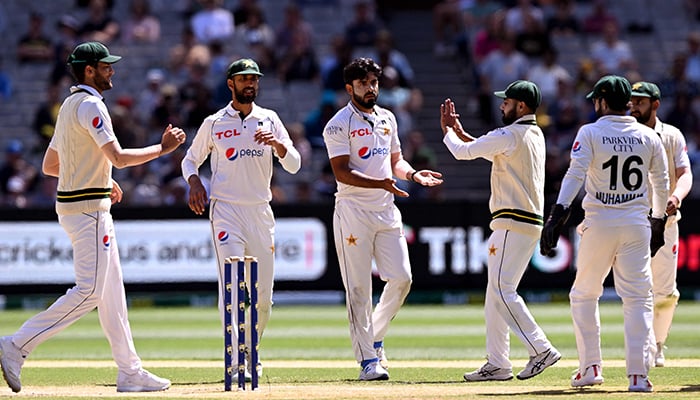 Pakistan bowler Aamer Jamal (centre) celebrates with teammates after dismissing Australian batsman Pat Cummins on the fourth day of the second cricket Test match between Australia and Pakistan at the Melbourne Cricket Ground (MCG) in Melbourne on December 29, 2023. — AFP