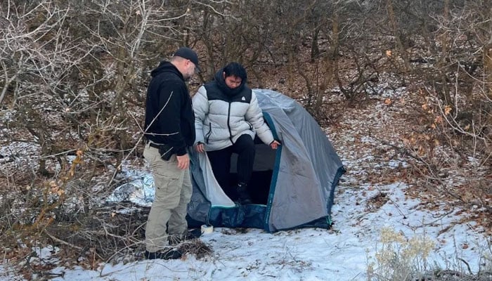 Kai Zhuang leaves his tent in rural Utah after being found following his cyber kidnapping. — BBC via Riverdale Police Department