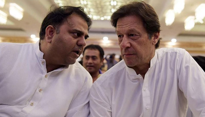 Former information minister Fawad Chaudhry (L) and Pakistan Tehreek-e-Insaf (PTI) founder Imran Khan in a conversation. — AFP/File