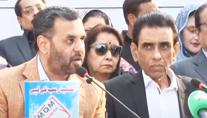 Muttahida Qaumi Movement-Pakistan Convener Dr Khalid Maqbool Siddiqui (right) and Senior Deputy Convener Mustafa present the partys manifesto during the press conference in Karachi on January 4, 2024, in this still taken from a video. — YouTube/PTV News