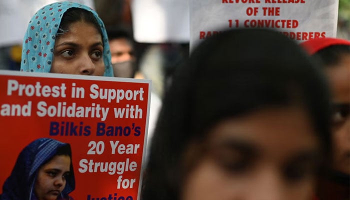 Demonstrators hold placards during a protest against the release of men convicted of gang-raping of Bilkis Bano during the 2002 communal riots in Gujarat, in New Delhi on August 27, 2022. — AFP