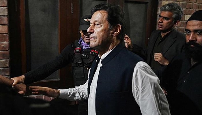 FReserormer prime minister Imran Khan (centre) leaves after appearing at the Lahore High Court on March 17, 2023. — AFP/File