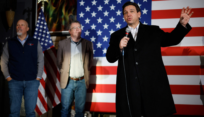Republican presidential candidate Florida Governor Ron DeSantis (R) is joined on stage by Rep. Chip Roy (R-TX) (L) and Rep. Thomas Massie (R-KY) (2nd-L) during an event at the Chrome Horse Saloon on January 14, 2024 in Cedar Rapids, Iowa. — AFP
