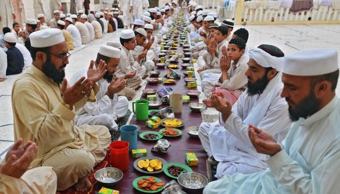 Pakistani Muslims pray before breaking their fast at a mosque during the first day of Ramadan in Peshawar, Pakistan, on July 11, 2013. — AFP