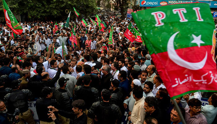 File photo shows supporters of PTI protest on street against the disqualification decision of former prime minister Imran Khan in Karachi on October 21, 2022. — AFP