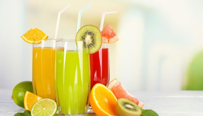 Three glasses of fresh fruit juices kept on a table. — X/@freepik