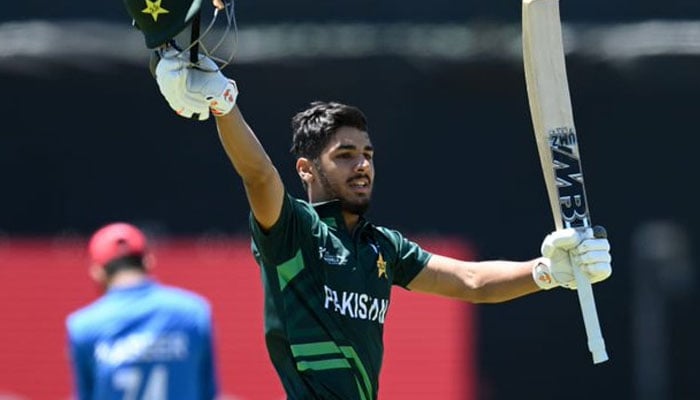 Shahzaib Khan waves his bat after smashing a century against Afghanistan on January 20, 2024. —X/@ICC