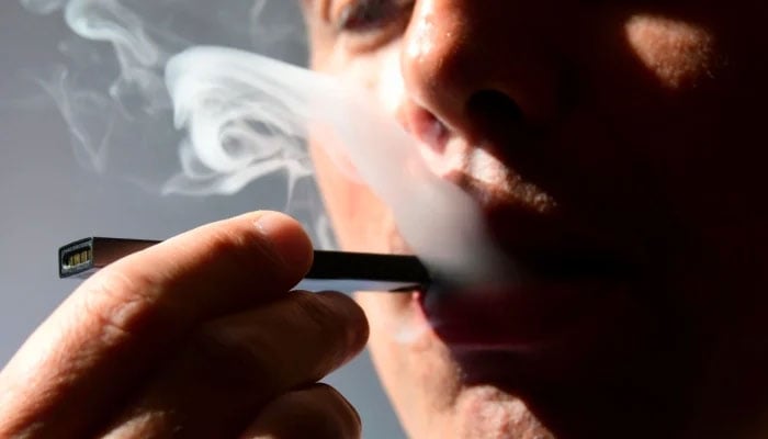 A representational image showing a person smoking an e-cigarette. — AFP/File