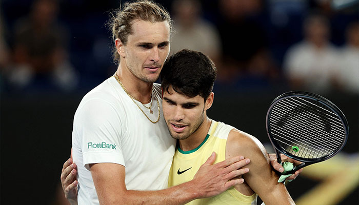 Germany’s Alexander Zverev (L) embraces Spain´s Carlos Alcaraz after their men’s singles quarter-final match on day 11 of the Australian Open tennis tournament in Melbourne on January 25, 2024. — AFP