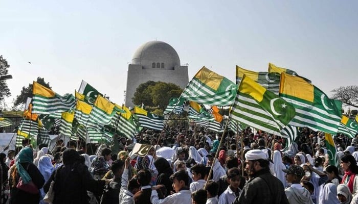 Demonstrators hold Kashmir’s flags and chant slogans as they march in solidarity with the people of IIOJK, during an event in Karachi. — AFP