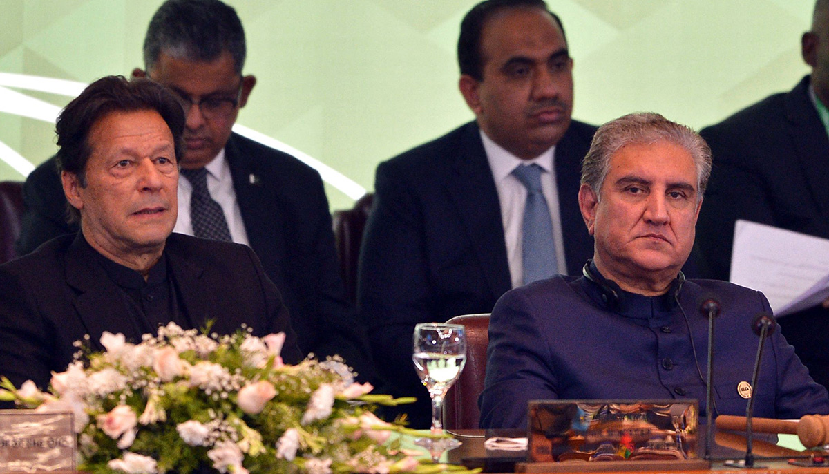 PTI founder Imran Khan and party leader Shah Mahmood Qureshi attend the opening of a special meeting of the 57-member OIC in Islamabad on December 19, 2021. — AFP