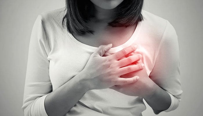 Representational image of a woman having heart pain. — Yale News